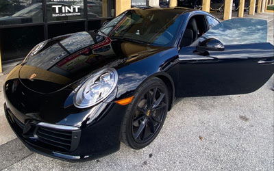 porsche in front of shop